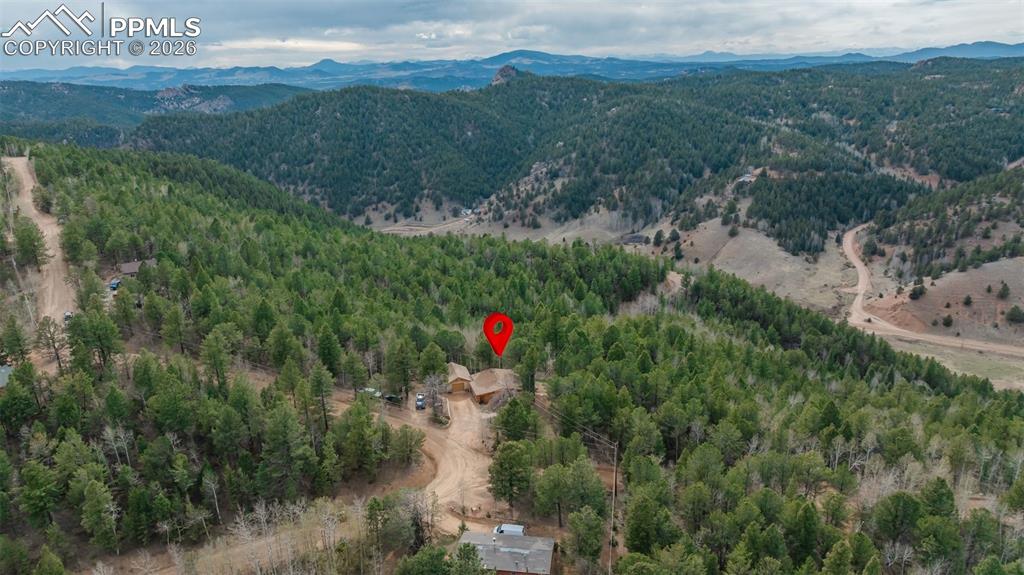 Image 33 of 41: Expansive aerial showcasing a private residence nestled amidst a dense fore