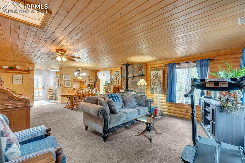 Image 5 of 41: Expansive living area featuring light wood-finish walls and ceiling, a skyl