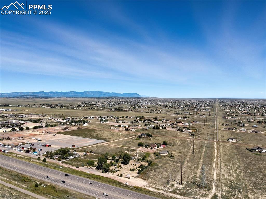 Image 12 of 12: Overview of rural landscape featuring a mountainous background