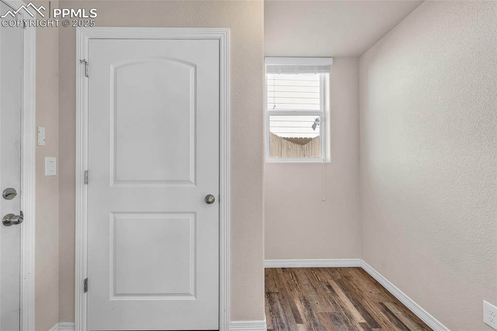 Image 17 of 44: Hall with dark wood-type flooring and a textured wall