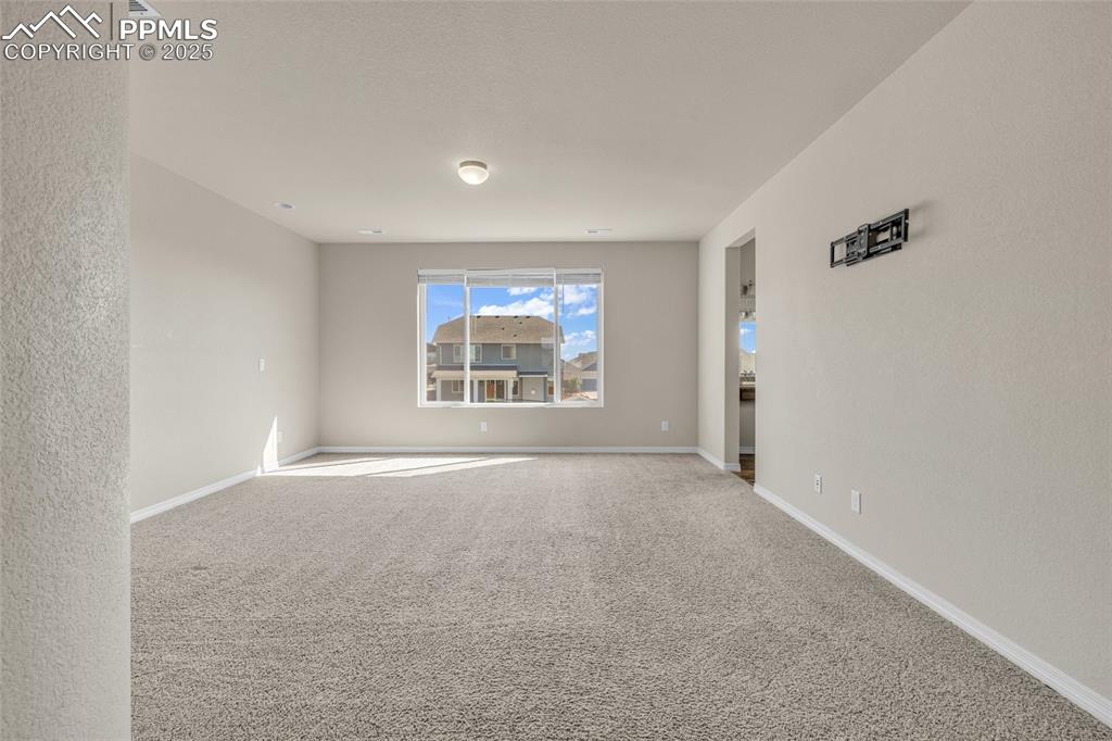 Image 20 of 44: Unfurnished room with carpet and baseboards