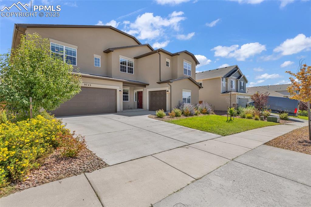 Image 3 of 44: Traditional-style home featuring an attached garage, driveway, stucco sidin