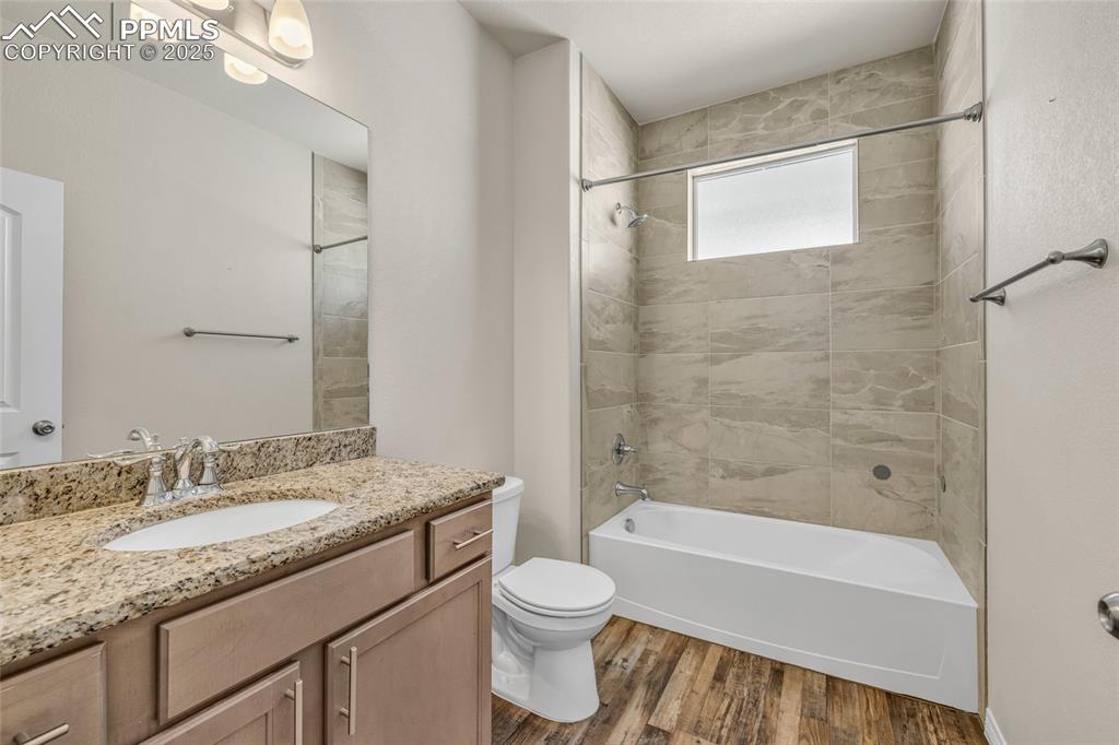 Image 33 of 44: Full bath with shower / washtub combination, vanity, and dark wood-style fl