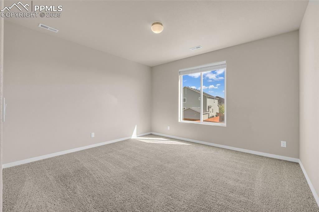 Image 34 of 44: Empty room featuring light colored carpet and baseboards