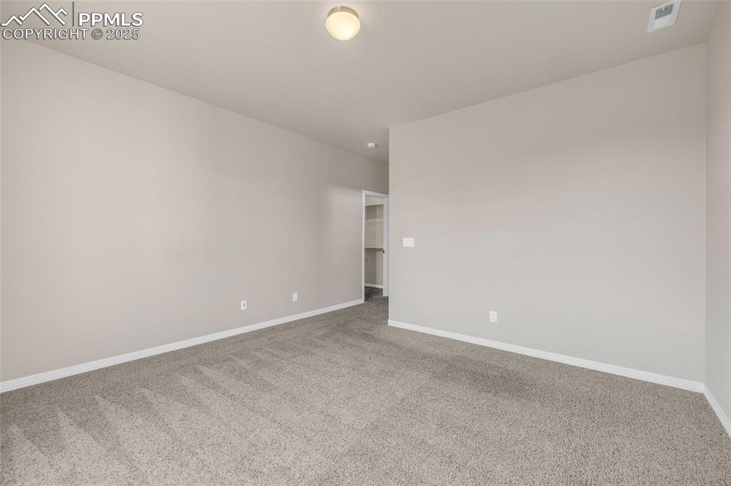 Image 37 of 44: Carpeted empty room featuring baseboards