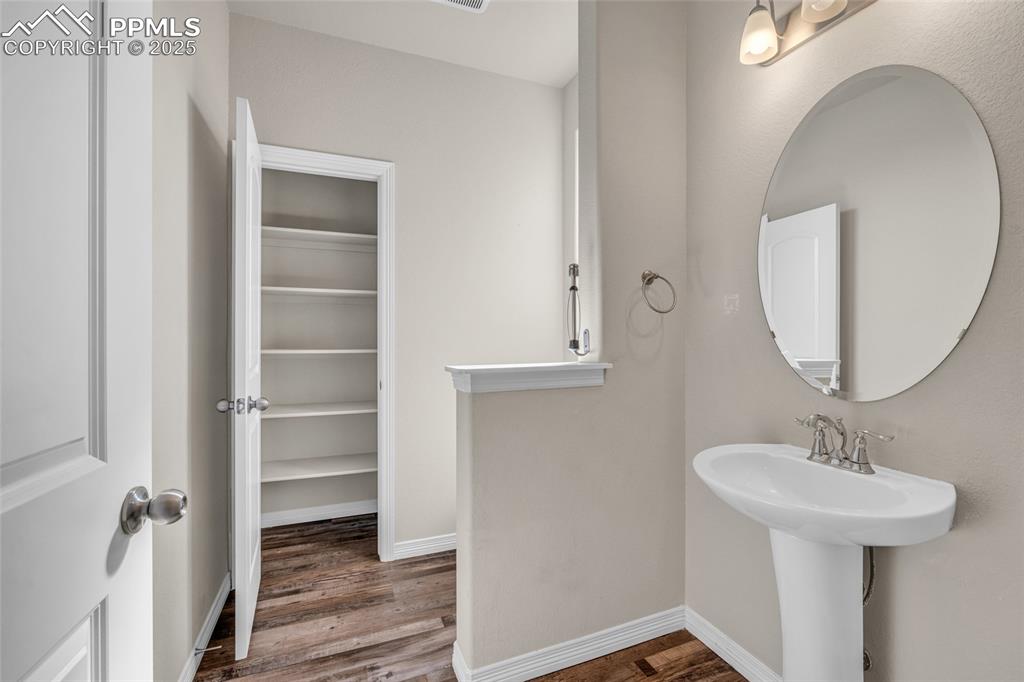 Image 8 of 44: Bathroom with wood finished floors and a spacious closet