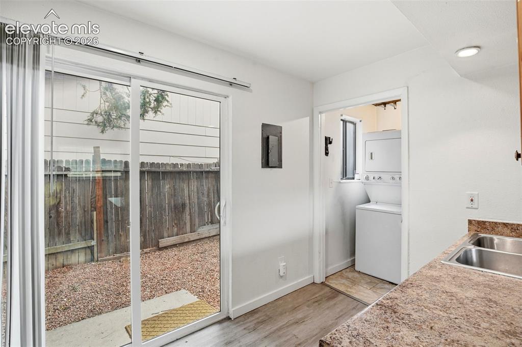 Image 11 of 31: Walk Out from Kitchen to Fenced Patio Area