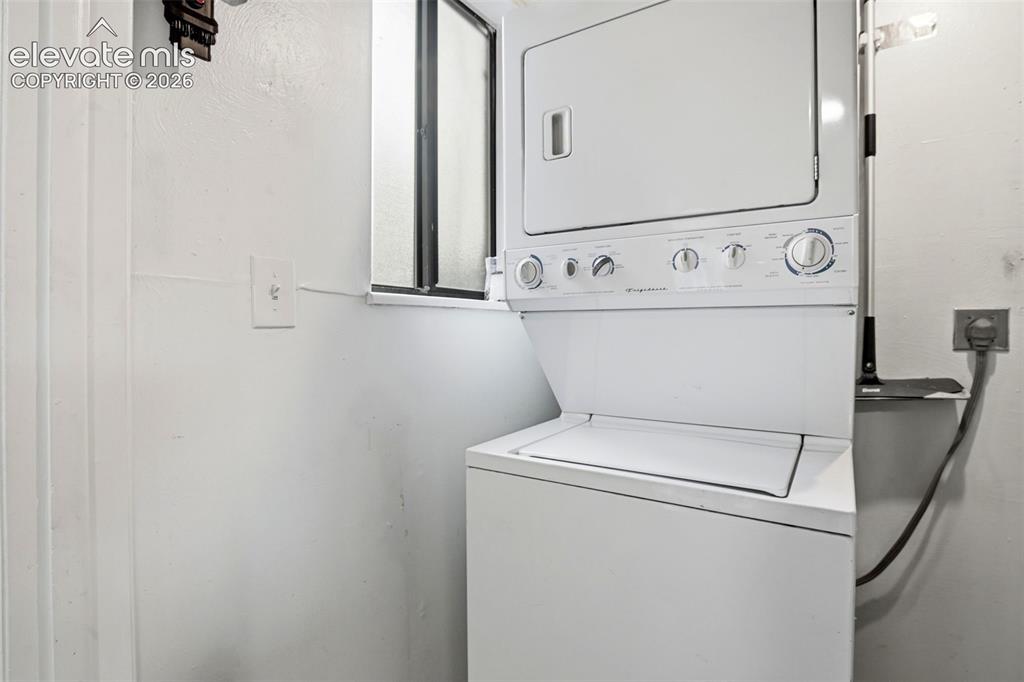 Image 16 of 31: White stacked washer and dryer unit