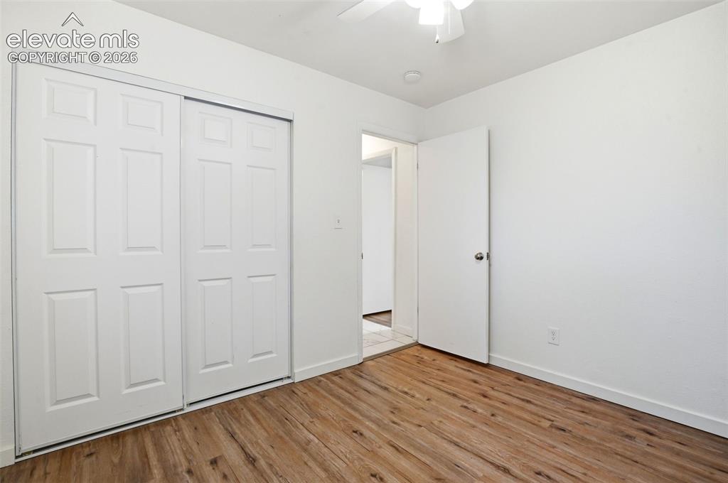 Image 22 of 31: Spacious Office, could be a Bedroom featuring warm wood-finish flooring, du