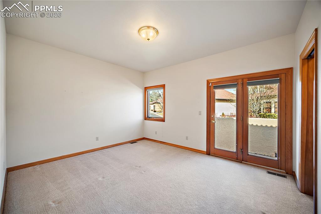 Image 24 of 44: Main Level Bedroom with Private Patio