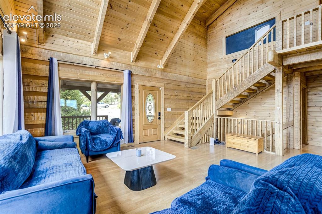 Image 11 of 50: Vaulted wood-paneled ceiling with exposed beams, wood-finish flooring, and