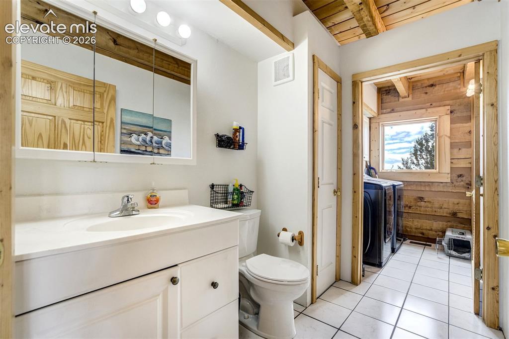 Image 17 of 50: Bathroom with a white vanity featuring an integrated sink and base cabinetr