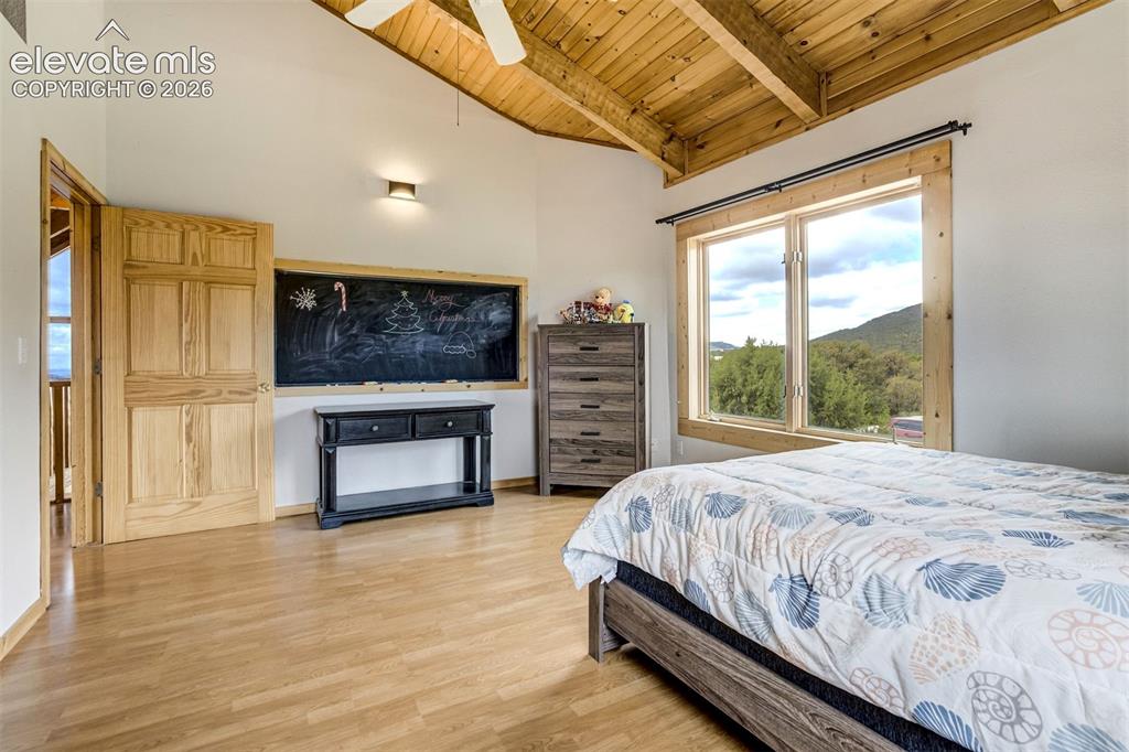 Image 24 of 50: Room featuring a vaulted wood-paneled ceiling, wood-finish flooring, and a
