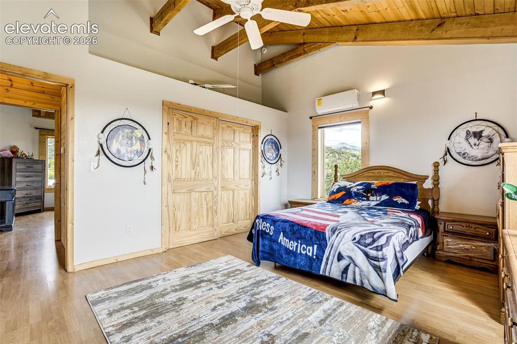 Image 26 of 50: Vaulted wooden plank ceiling with exposed beams