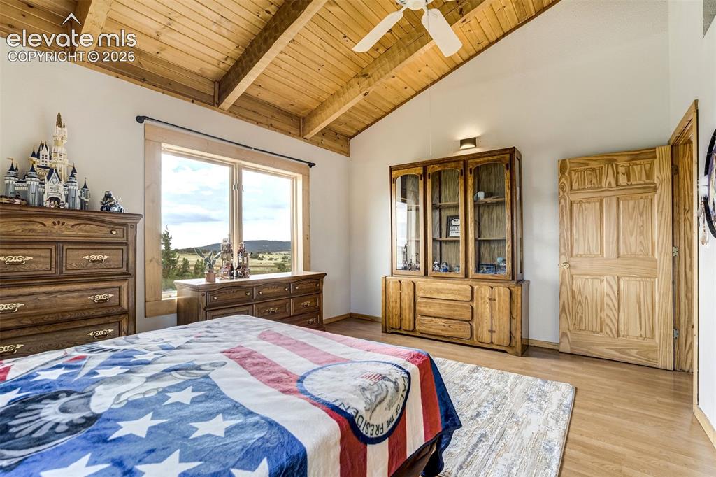Image 27 of 50: Vaulted wood-paneled ceiling with exposed beams