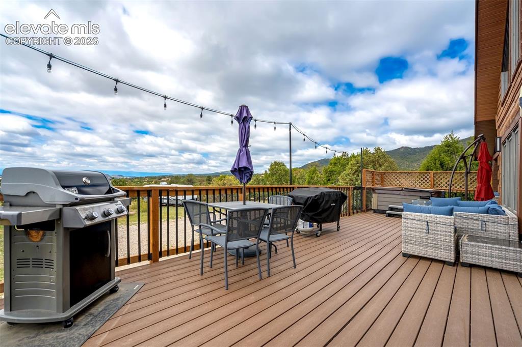 Image 45 of 50: Expansive outdoor deck featuring wood-finish flooring and black metal raili