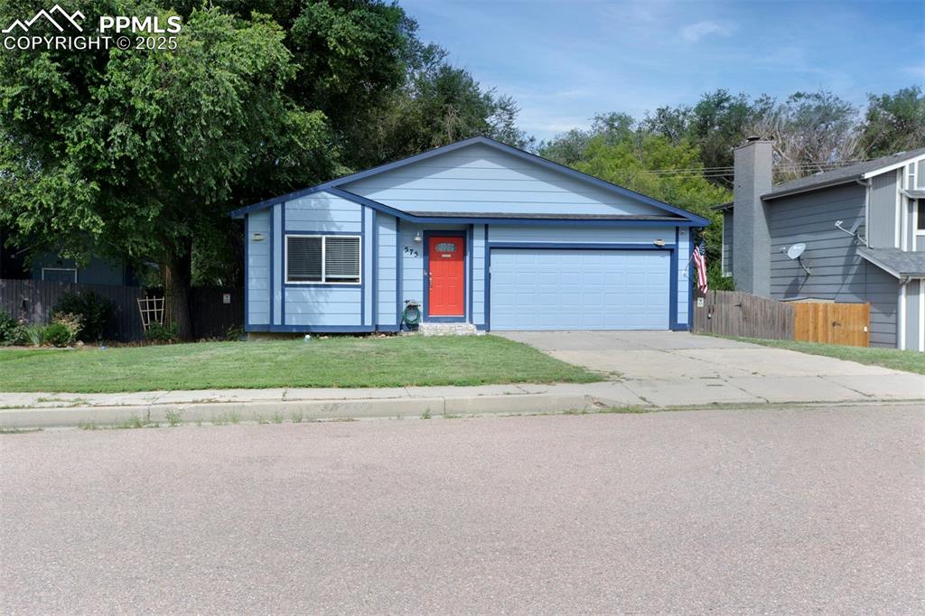Caption: Ranch-style home with red front door and garage