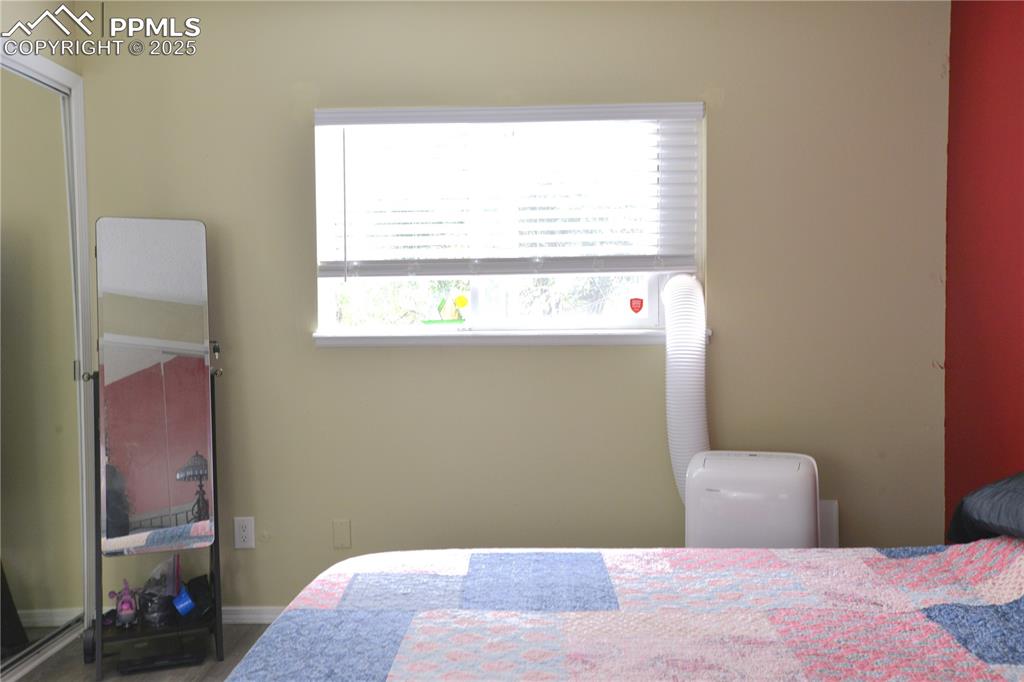 Image 16 of 29: Bedroom with window and closet