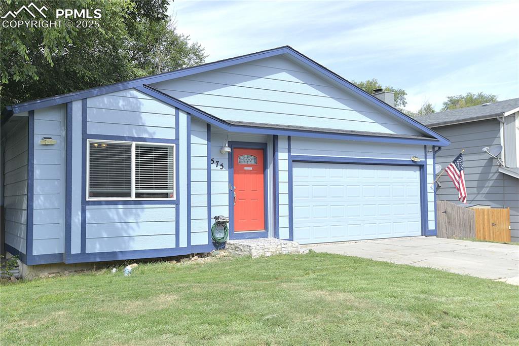 Image 2 of 29: Ranch-style home with red front door and garage