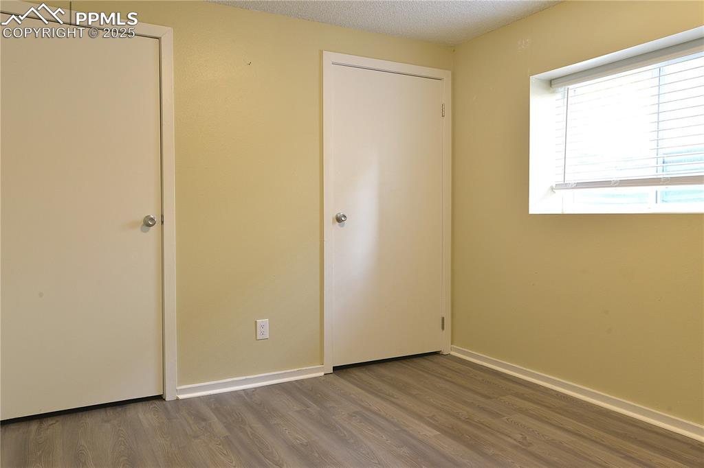 Image 26 of 29: 2nd Basement Level Bedroom with Large Closets and Light Filled Window