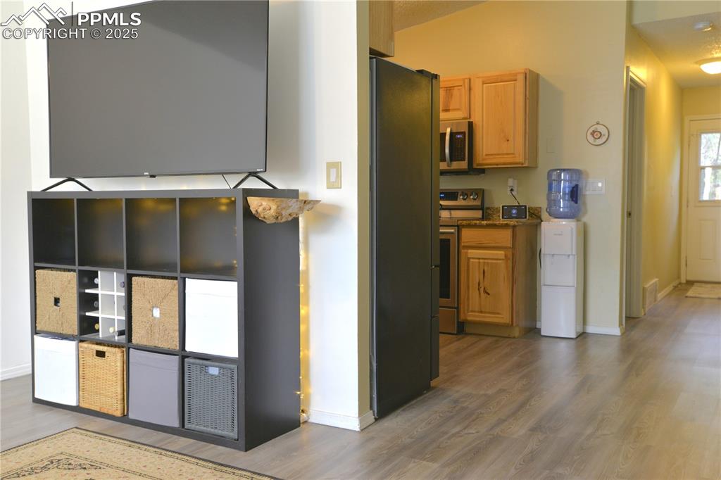 Image 7 of 29: Living area with view into dining and kitchen areas