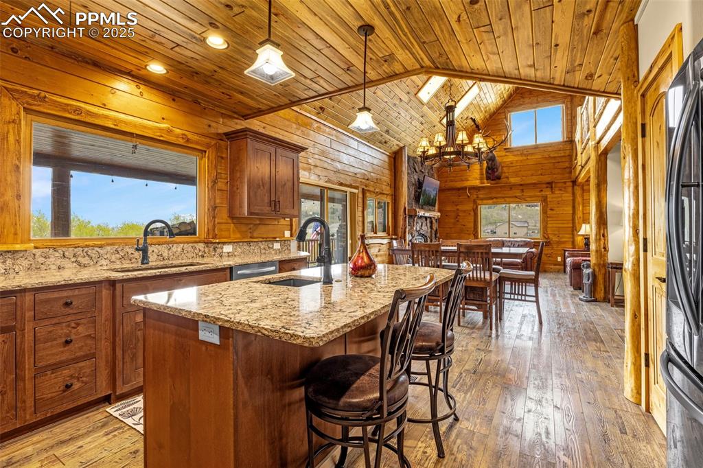 Image 10 of 45: Kitchen featuring healthy amount of natural light, a sink, wooden ceiling,