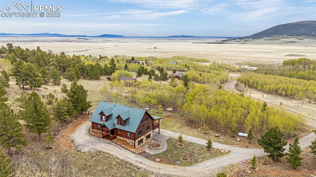 Image 42 of 45: View from above of property with a mountainous background