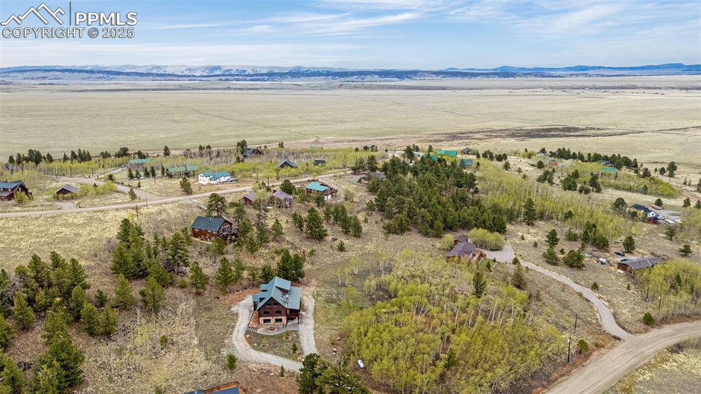 Image 45 of 45: Aerial view of sparsely populated area with a mountain backdrop