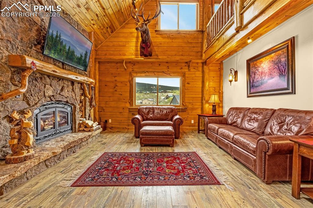 Image 6 of 45: Living room with plenty of natural light, high vaulted ceiling, hardwood /