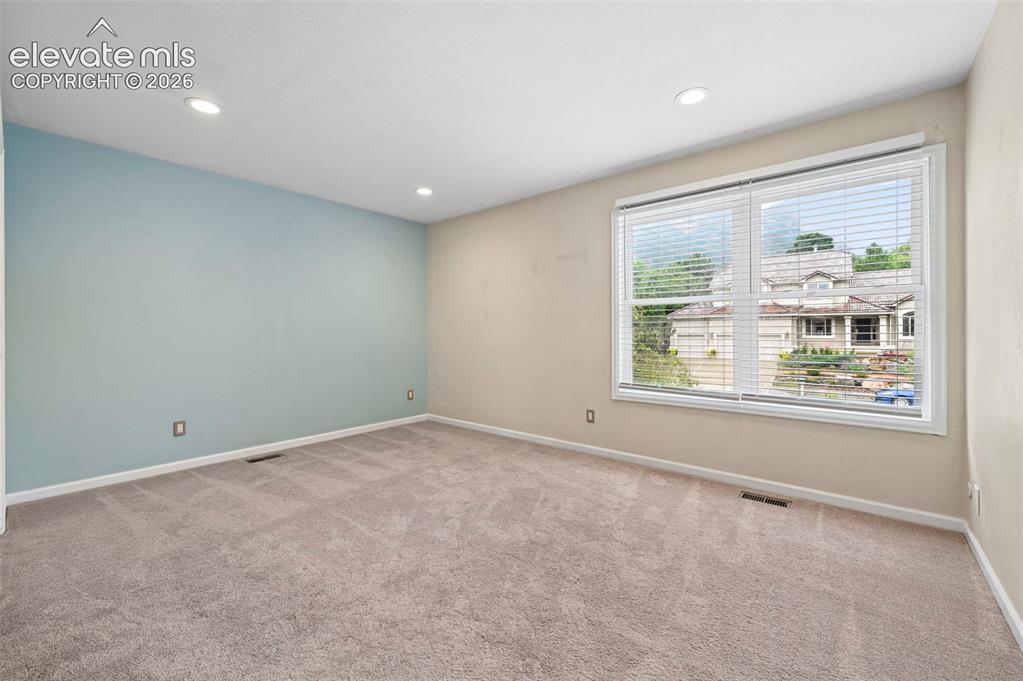 Image 28 of 45: Upstairs bedroom with incredible views of Cheyanne mountain 