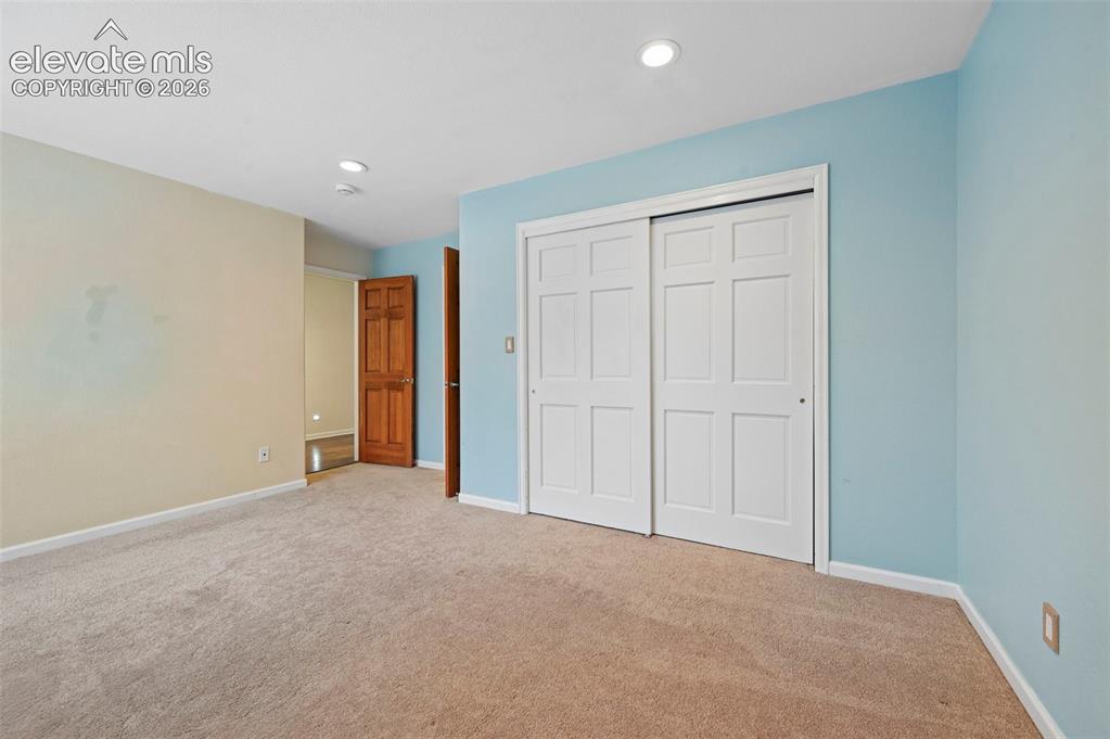 Image 29 of 45: Upstairs bedroom with incredible views of Cheyenne mountain 