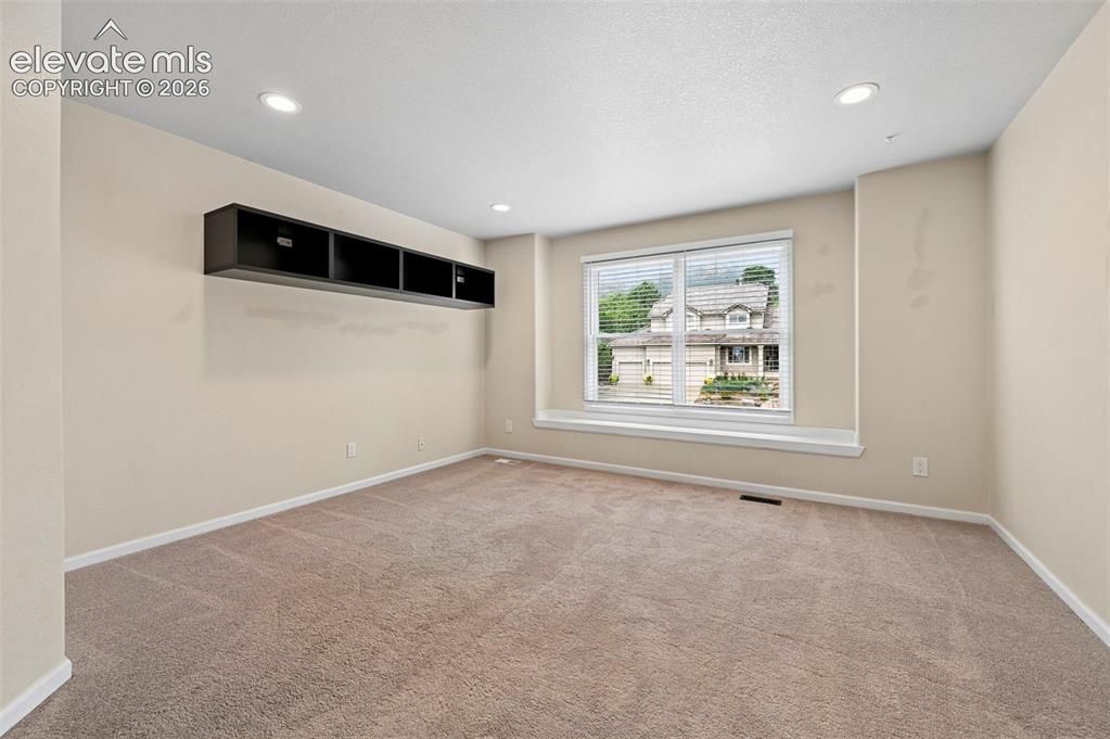 Image 30 of 45: Upstairs bedroom with incredible views of Cheyanne mountain