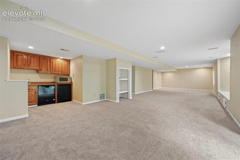 Image 36 of 45: Large walkout basement with wetbar 