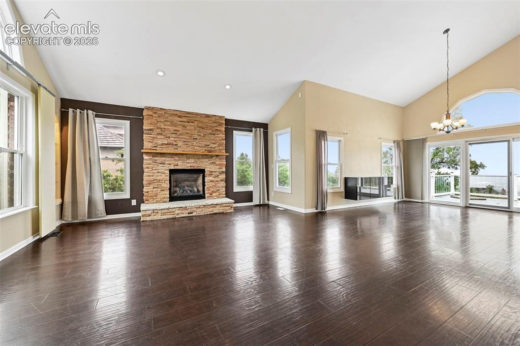 Image 6 of 45: Formal living room and dining room with walk out to large deck, overlooking