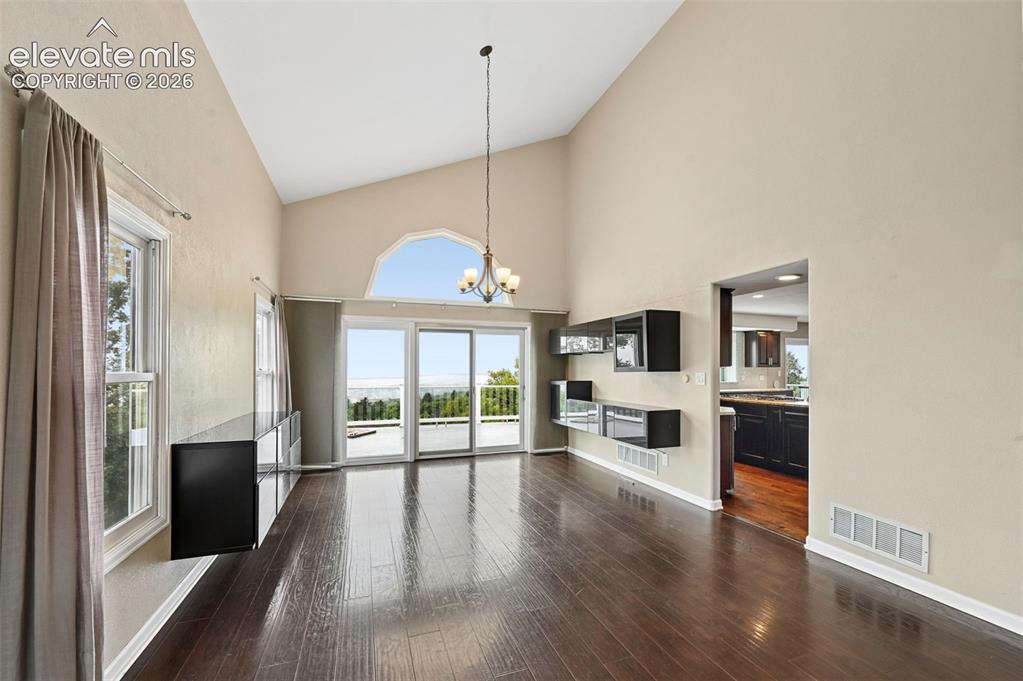 Image 8 of 45: Dining room with walkout to large upper deck