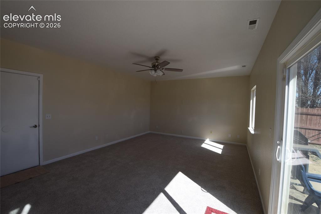 Image 15 of 44: Carpeted living space featuring neutral wall tones, a ceiling fan with inte