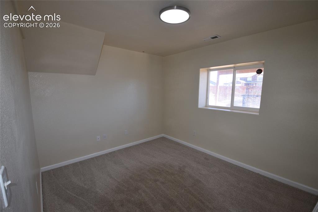 Image 24 of 44: Room featuring light neutral wall paint, a single window with white framing