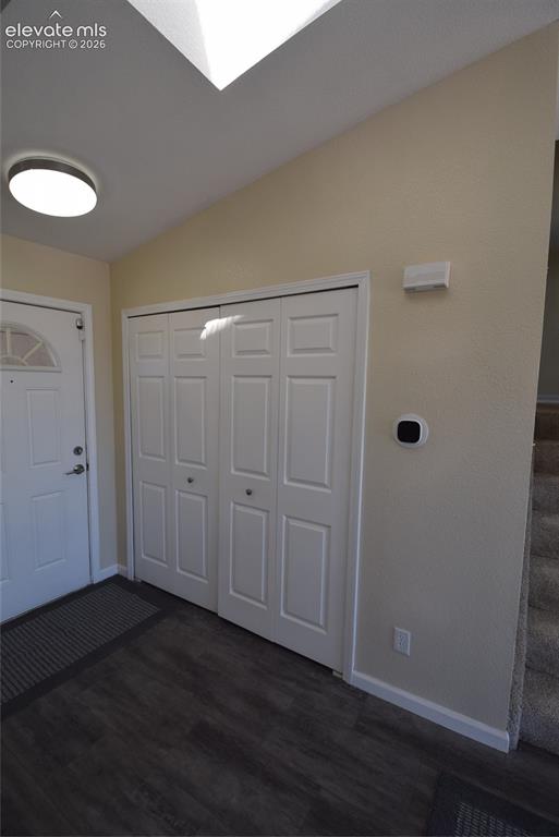 Image 33 of 44: Foyer featuring dark wood-finish flooring, white bi-fold closet doors, a wh