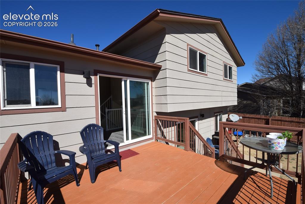 Image 40 of 44: Expansive outdoor deck featuring wood-finish flooring and sturdy wood raili