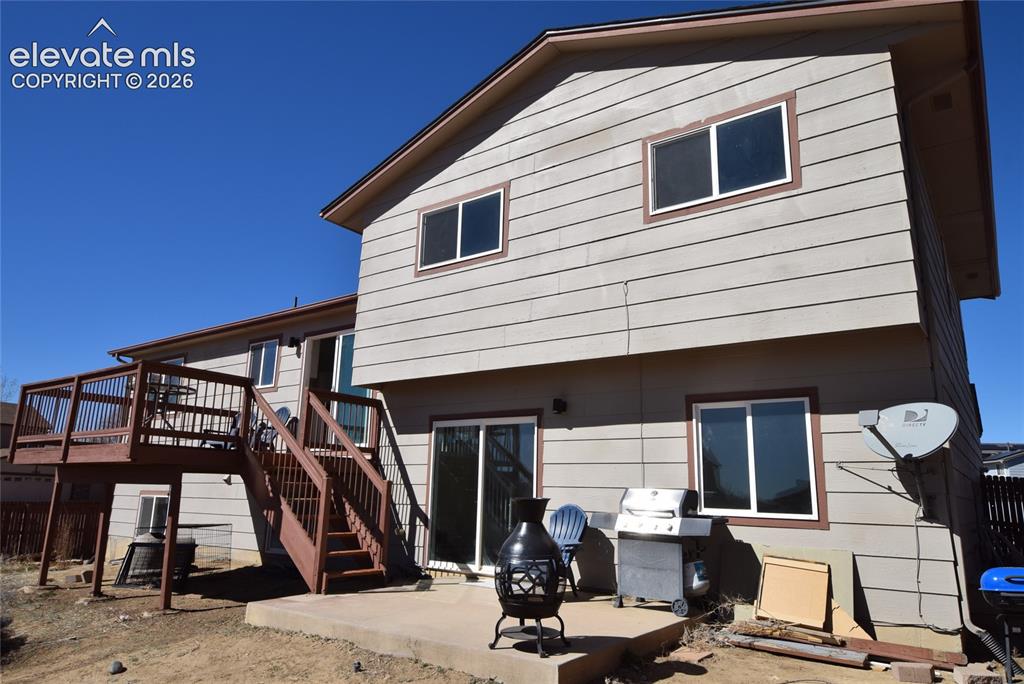 Image 41 of 44: Two-story property featuring horizontal siding, a multi-level wood deck, an