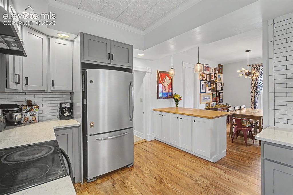 Image 24 of 50: Kitchen to dining room open floor concept emphasizing an open and inviting