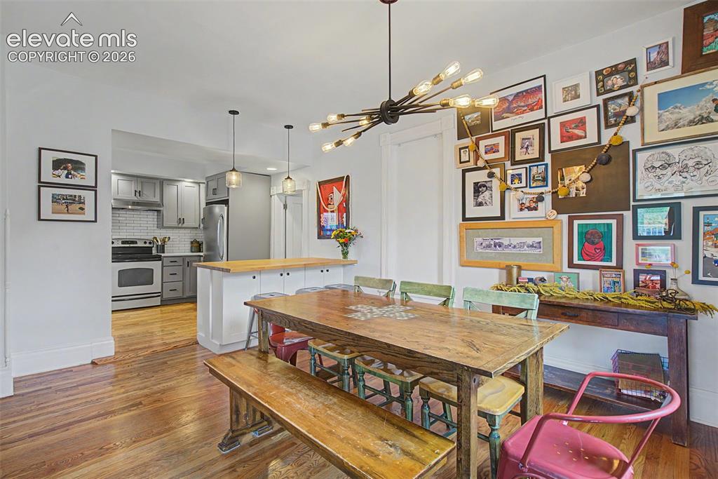Image 29 of 50: Dining area featuring wood-finish flooring and an open concept layout