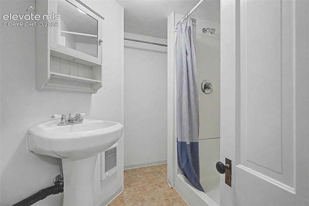 Image 41 of 50: Secondary suite 3/4 bathroom with a closet