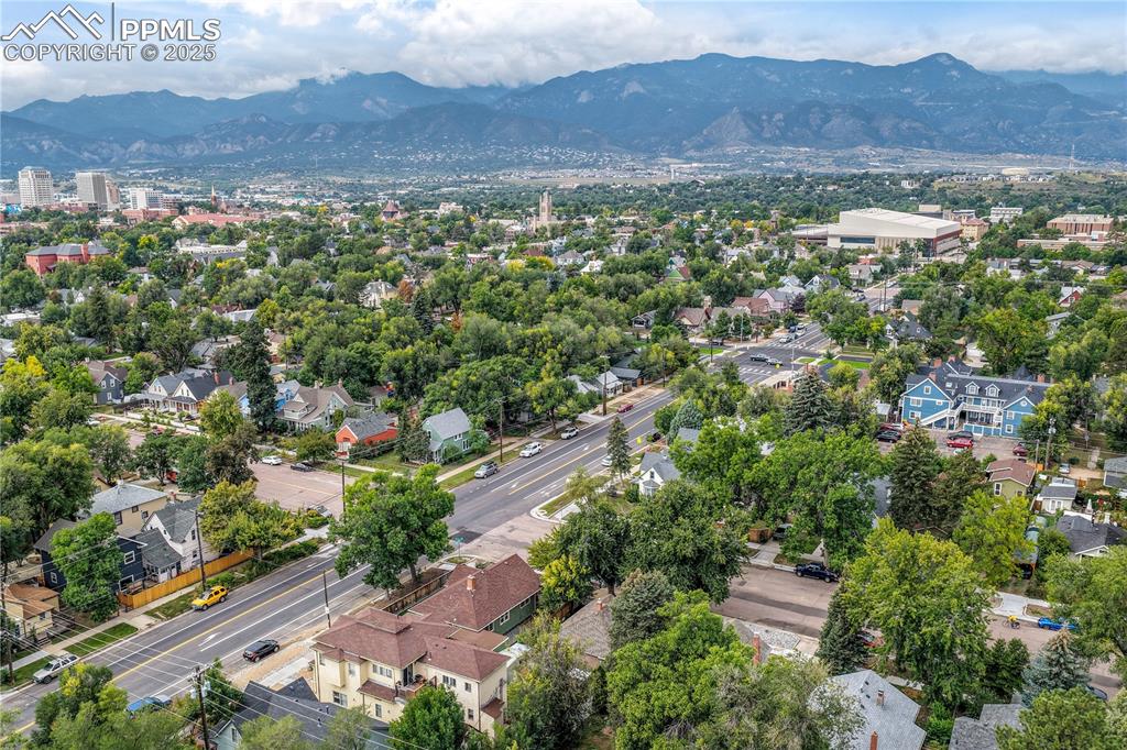 Image 50 of 50: Aerial view of residential area with a mountain backdrop