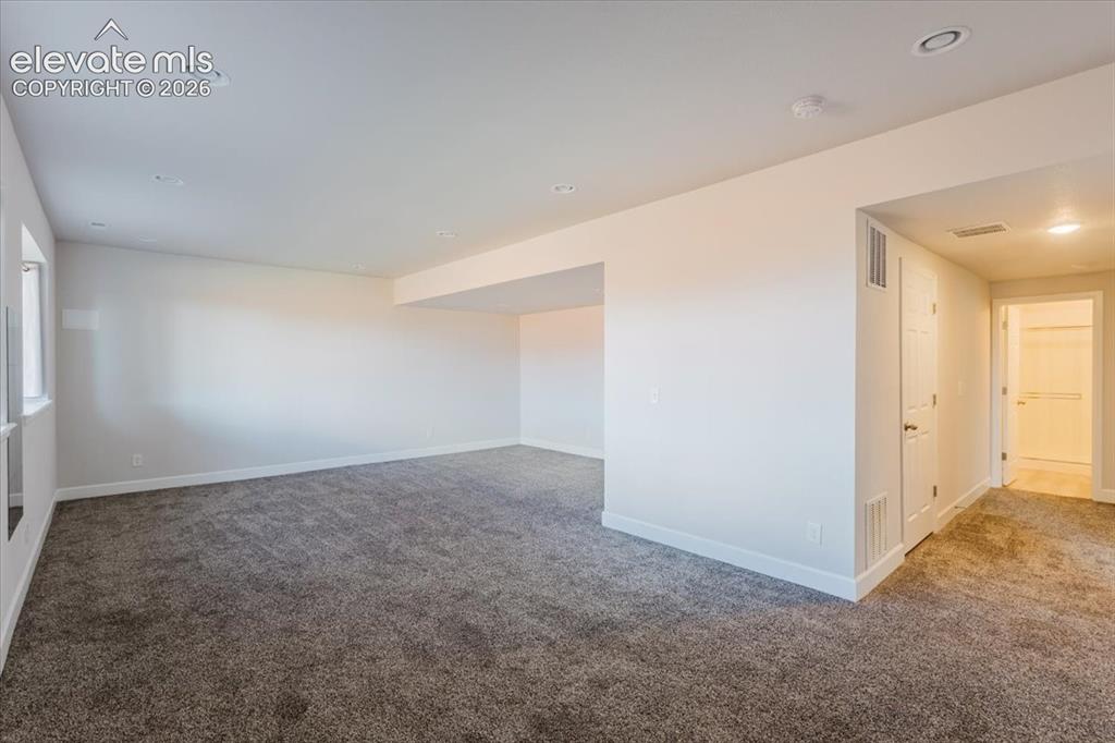 Image 20 of 50: Expansive interior space featuring neutral wall paint, recessed lighting, a