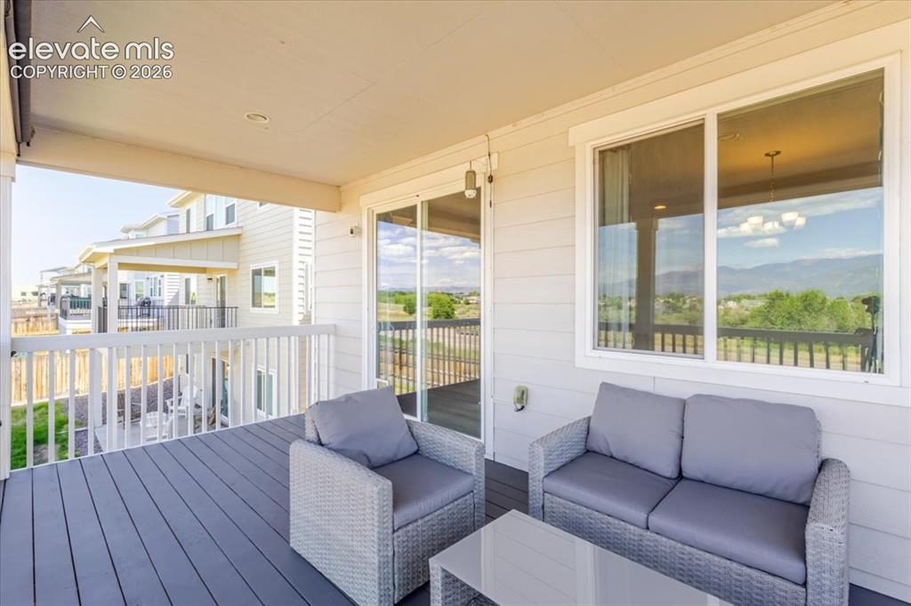 Image 24 of 50: Covered outdoor deck with composite decking and white railing