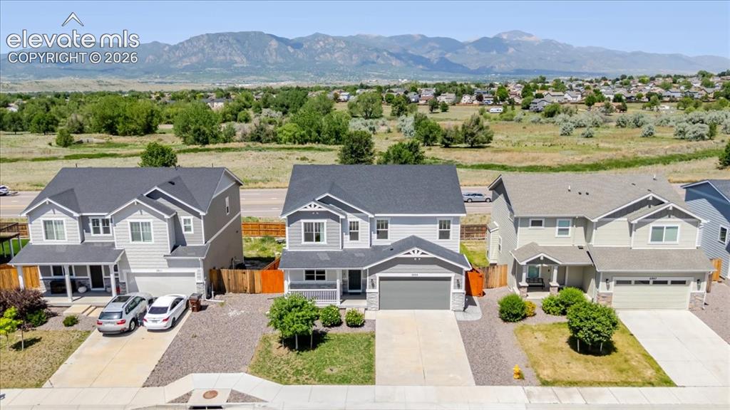 Image 3 of 50: Modern two-story residence featuring a dark gray roof and light gray siding