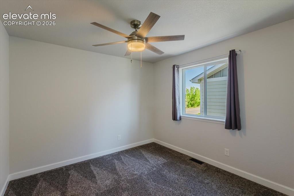 Image 30 of 50: Neutral wall finishes complement the grey textured carpeting