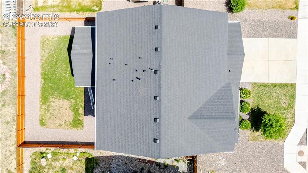 Image 4 of 50: Asphalt shingle roof with multiple vents and a distinct hip design