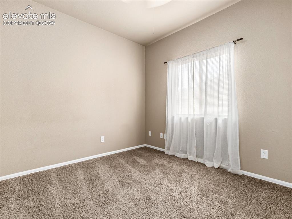 Image 17 of 24: Neutral-toned walls complement the textured carpeting